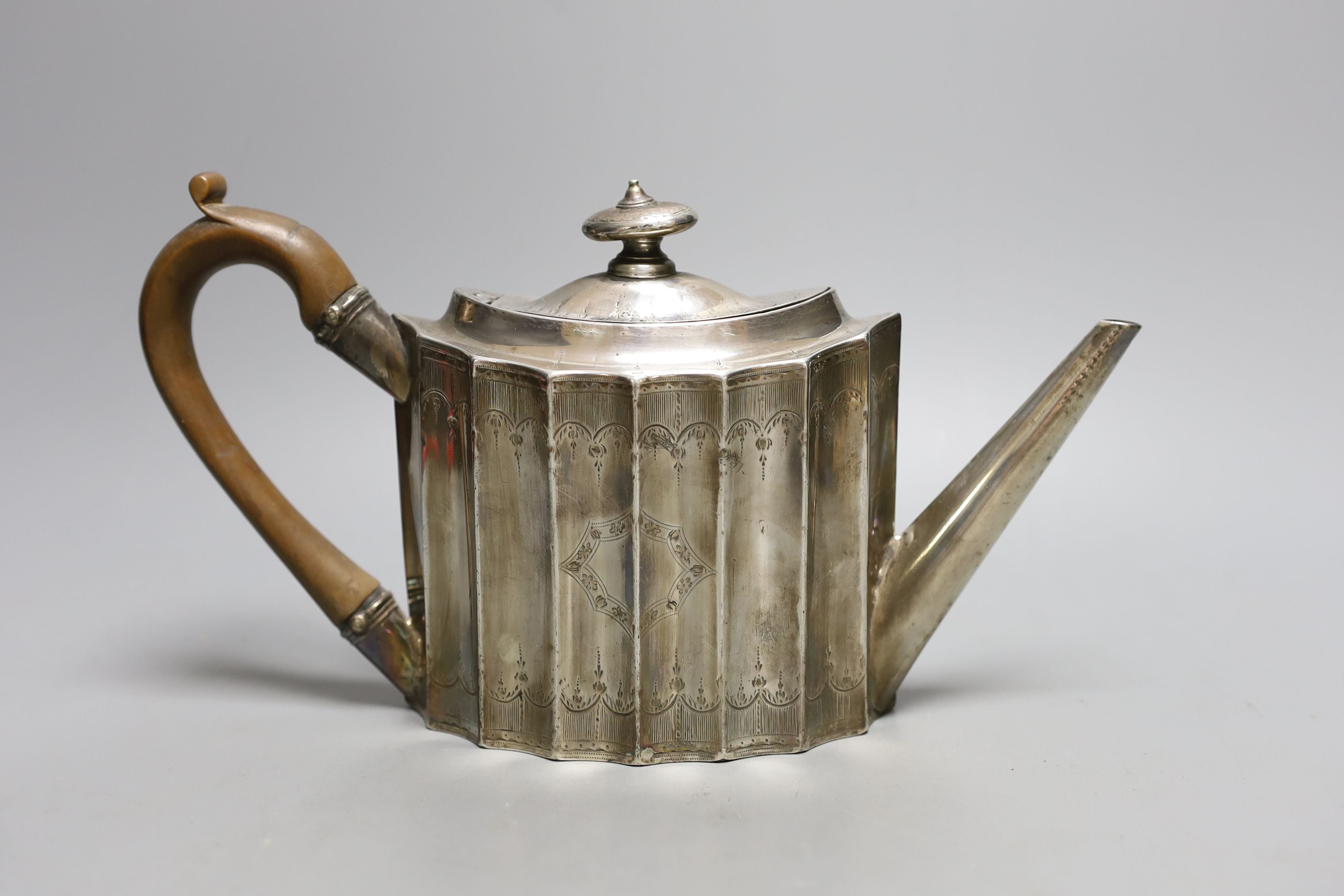 A George III engraved silver oval 'batwing' shaped teapot, George Smith II, London, 1788, gross weight 14.5oz.